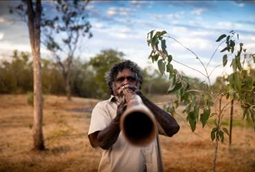 Playing the Didgeridoo at Top Didj Cultural Experience and Art Gallery - Tourism NT/Geoffrey Reid