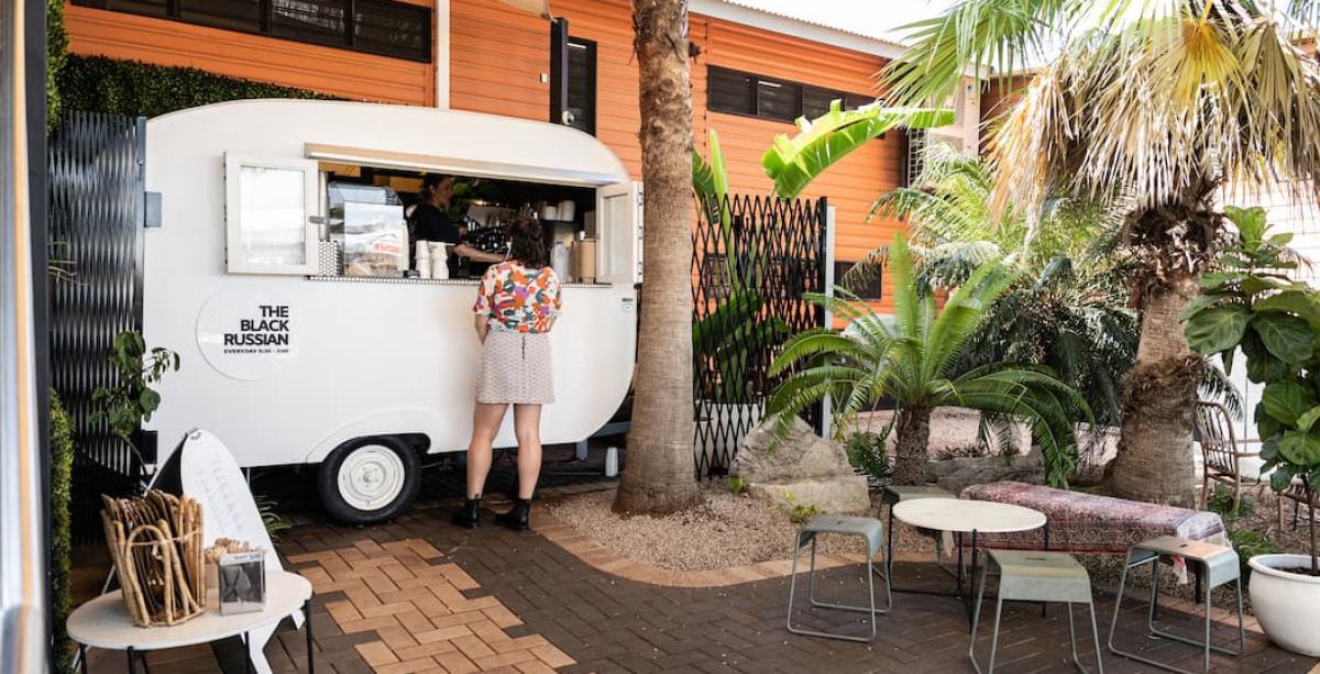 A person ordering at the Black Russian Caravan Bar