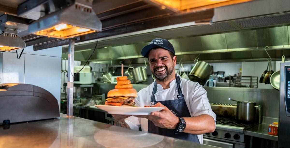 Chef is serving a burger 